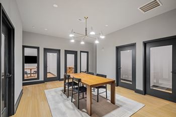 a dining room with a wooden table and chairs